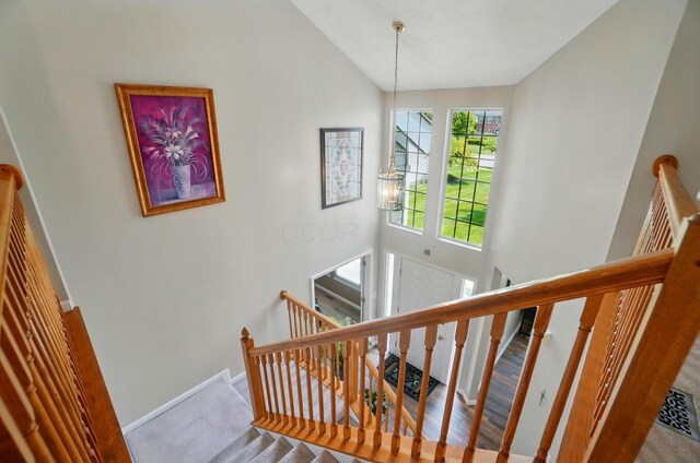 583 Marhurst Ct, Galloway, OH 43119 - staircase featuring carpet flooring, baseboards, and high vaulted ceiling