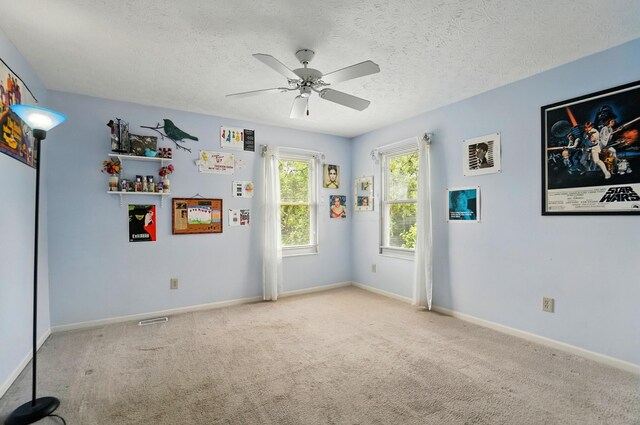583 Marhurst Ct, Galloway, OH 43119 - unfurnished room featuring a ceiling fan, carpet, baseboards, and a textured ceiling