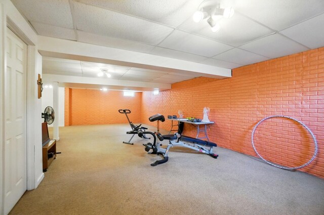 583 Marhurst Ct, Galloway, OH 43119 - exercise room with brick wall, carpet floors, and a drop ceiling
