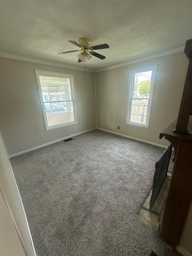 600 N Maple St, Lancaster, OH 43130 - empty room featuring crown molding, ceiling fan, carpet, baseboards, and a textured ceiling