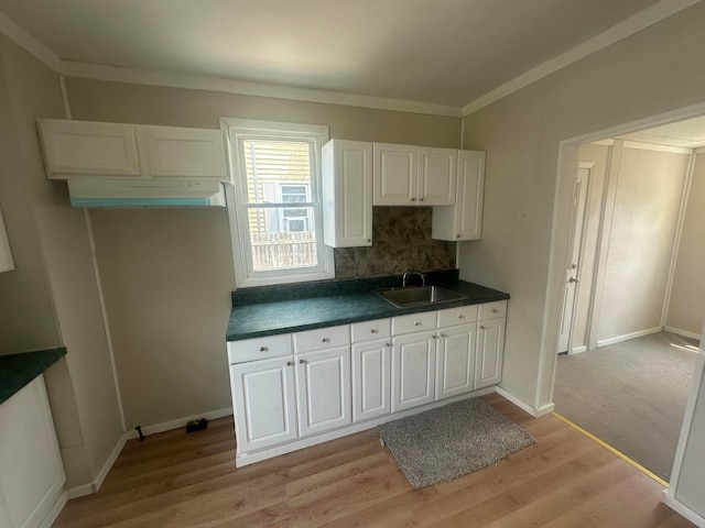 600 N Maple St, Lancaster, OH 43130 - kitchen featuring a sink, dark countertops, white cabinetry, light wood finished floors, and crown molding
