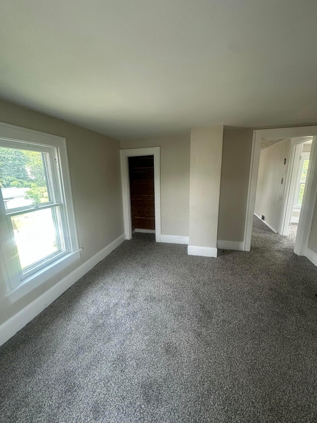 600 N Maple St, Lancaster, OH 43130 - spare room featuring baseboards, plenty of natural light, and dark colored carpet
