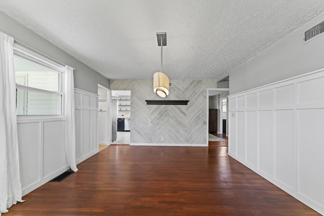 2147 Summit View Rd, Powell, OH 43065 - unfurnished living room with a decorative wall, a textured ceiling, and wood finished floors