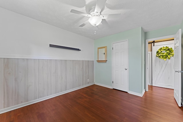 2147 Summit View Rd, Powell, OH 43065 - unfurnished bedroom with wood finished floors, baseboards, a textured ceiling, a ceiling fan, and wainscoting