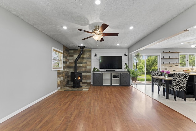 2147 Summit View Rd, Powell, OH 43065 - living area with a ceiling fan, a wood stove, wood finished floors, a textured ceiling, and recessed lighting