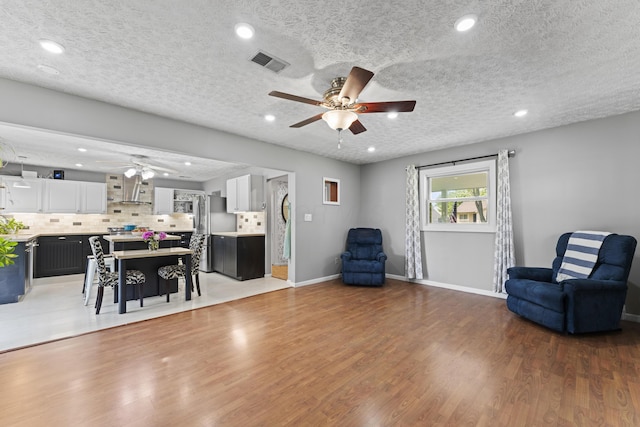 2147 Summit View Rd, Powell, OH 43065 - living area with a ceiling fan, wood finished floors, recessed lighting, baseboards, and a textured ceiling