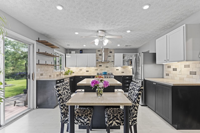 2147 Summit View Rd, Powell, OH 43065 - kitchen with open shelves, wall chimney exhaust hood, ceiling fan, light countertops, and a textured ceiling