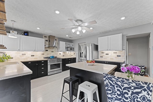2147 Summit View Rd, Powell, OH 43065 - kitchen with appliances with stainless steel finishes, wall chimney range hood, a sink, dark cabinets, and backsplash