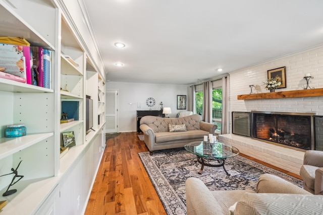 2171 Northam Rd, Columbus, OH 43221 - living area with crown molding, hardwood / wood-style flooring, a fireplace, and recessed lighting