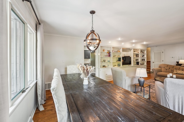 2171 Northam Rd, Columbus, OH 43221 - dining area featuring ornamental molding, a chandelier, wood finished floors, and baseboards
