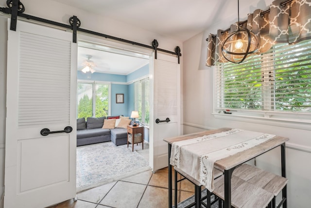 2171 Northam Rd, Columbus, OH 43221 - dining space featuring a barn door, tile patterned floors, and a chandelier