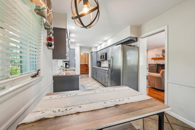 2171 Northam Rd, Columbus, OH 43221 - kitchen featuring stainless steel appliances, a sink, gray cabinets, light tile patterned floors, and light stone countertops