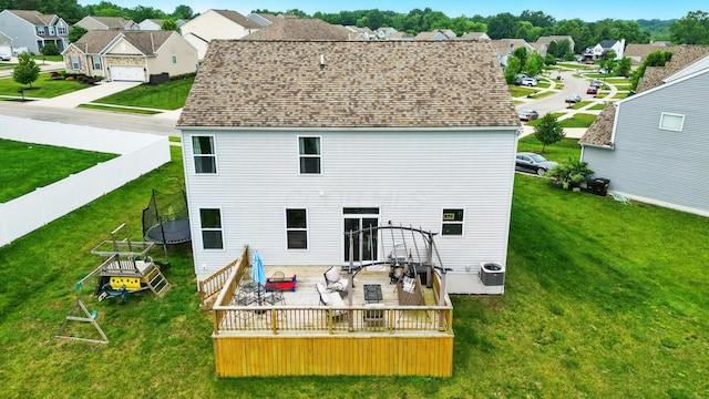 560 Green Forest Pl, Lithopolis, OH 43136 - back of property with a trampoline, a residential view, a wooden deck, and a fenced backyard