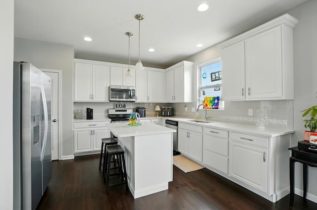560 Green Forest Pl, Lithopolis, OH 43136 - kitchen with stainless steel appliances, backsplash, a kitchen island, dark wood-style floors, and recessed lighting