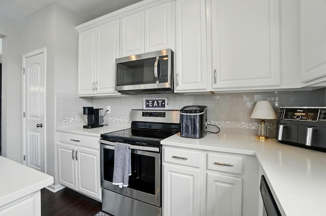 560 Green Forest Pl, Lithopolis, OH 43136 - kitchen with stainless steel appliances, decorative backsplash, white cabinetry, and light countertops