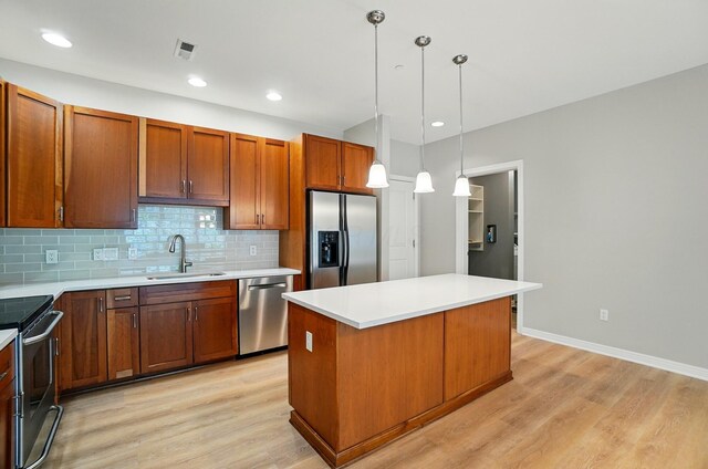 250 Daniel Burnham Sq Unit 304, Columbus, OH 43215 - kitchen with appliances with stainless steel finishes, light wood finished floors, backsplash, a kitchen island, and recessed lighting