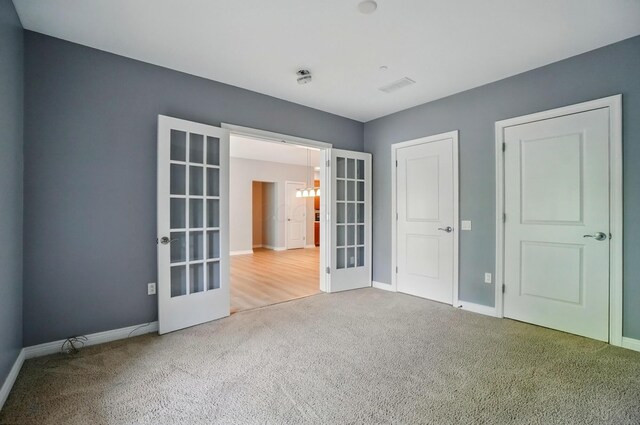 250 Daniel Burnham Sq Unit 304, Columbus, OH 43215 - unfurnished bedroom with french doors and carpet