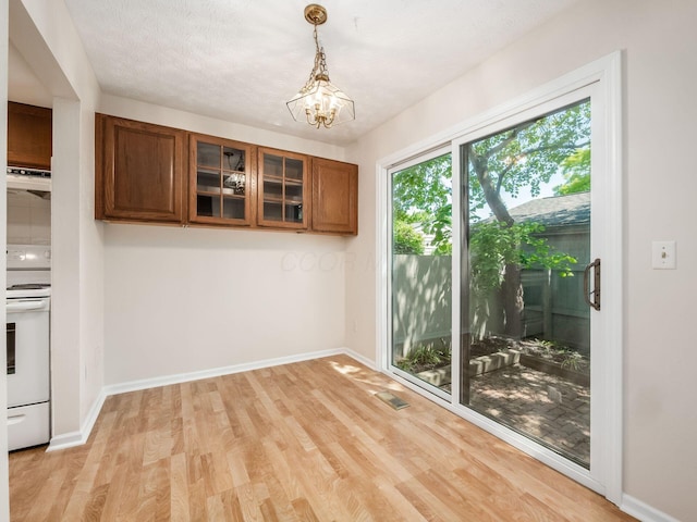 3120 Walden Ravines, Columbus, OH 43221 - unfurnished dining area featuring light wood finished floors, baseboards, and a chandelier