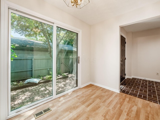 3120 Walden Ravines, Columbus, OH 43221 - spare room with baseboards, a chandelier, and wood finished floors