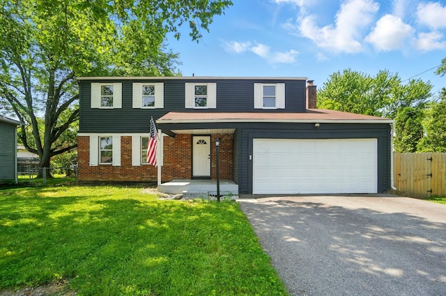 2605 Bella Via Ave, Columbus, OH 43231 - view of front facade with asphalt driveway, brick siding, a chimney, and a garage