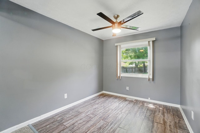 2605 Bella Via Ave, Columbus, OH 43231 - spare room with wood finished floors, ceiling fan, and baseboards