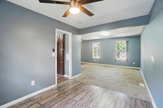2605 Bella Via Ave, Columbus, OH 43231 - empty room featuring wood finished floors, a ceiling fan, baseboards, and a textured ceiling