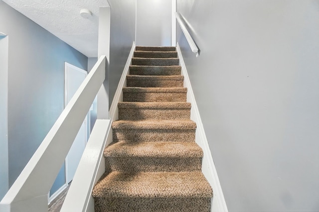 2605 Bella Via Ave, Columbus, OH 43231 - stairway featuring a textured ceiling