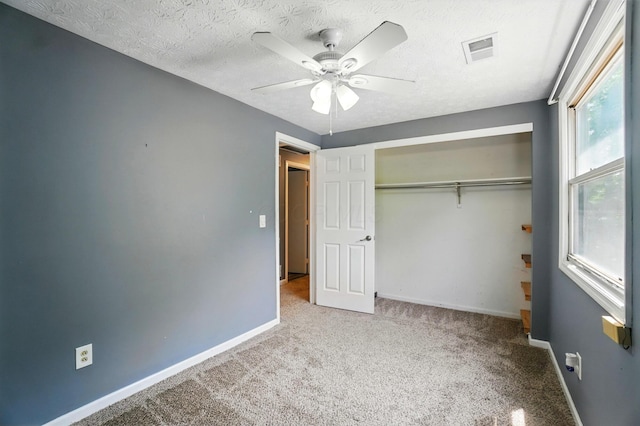 2605 Bella Via Ave, Columbus, OH 43231 - unfurnished bedroom with carpet, baseboards, a closet, a textured ceiling, and a ceiling fan