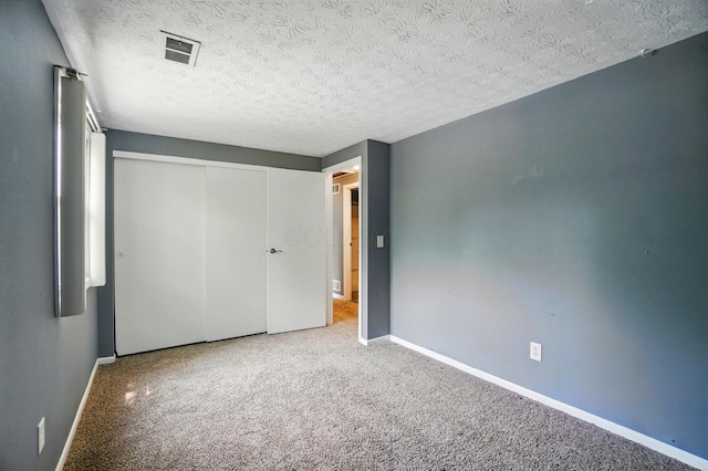 2605 Bella Via Ave, Columbus, OH 43231 - unfurnished bedroom with baseboards, carpet, a closet, and a textured ceiling