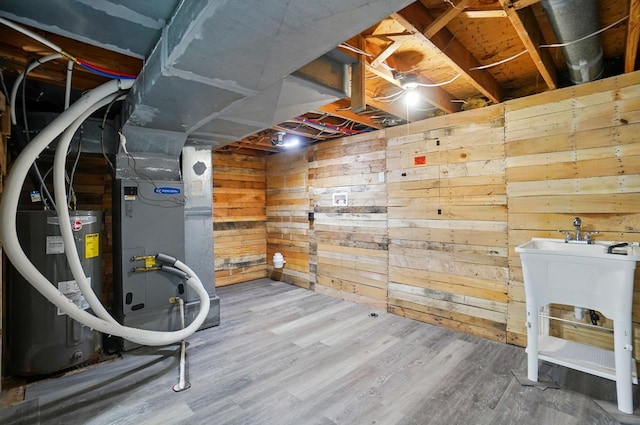 2605 Bella Via Ave, Columbus, OH 43231 - unfinished basement featuring water heater, wood finished floors, wooden walls, and heating unit