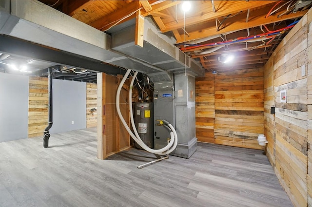 2605 Bella Via Ave, Columbus, OH 43231 - unfinished below grade area featuring electric water heater, wooden walls, wood finished floors, and heating unit