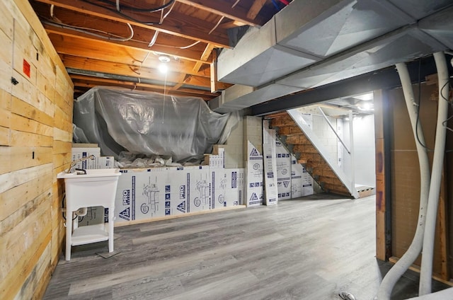 2605 Bella Via Ave, Columbus, OH 43231 - unfinished basement with wood walls, stairway, and wood finished floors