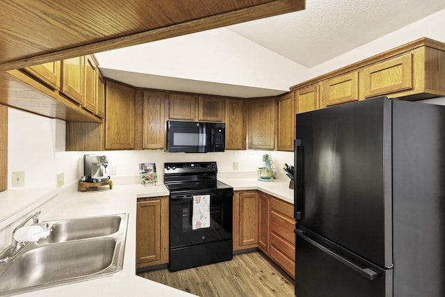 1318 Hillview Cir E, Newark, OH 43055 - kitchen with black appliances, a sink, light wood-style floors, and light countertops