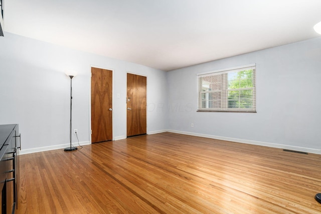 1775 NW Ct Unit 114 J, Columbus, OH 43212 - unfurnished bedroom with multiple closets, light wood-style flooring, and baseboards