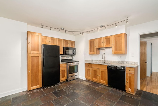 1775 NW Ct Unit 114 J, Columbus, OH 43212 - kitchen featuring black appliances, a sink, baseboards, and light stone countertops