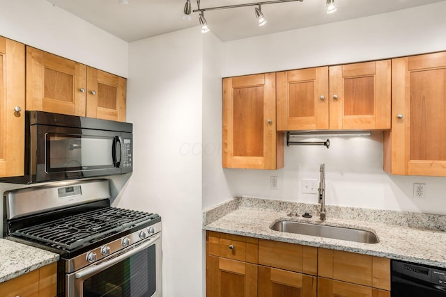 1775 NW Ct Unit 114 J, Columbus, OH 43212 - kitchen featuring black appliances, a sink, and light stone counters