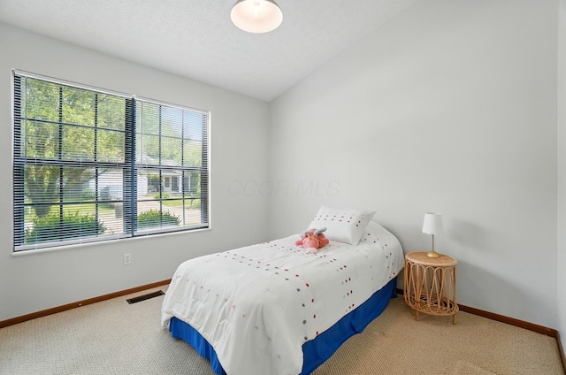 4557 Hidden Ridge Ct, Columbus, OH 43230 - carpeted bedroom featuring baseboards and lofted ceiling