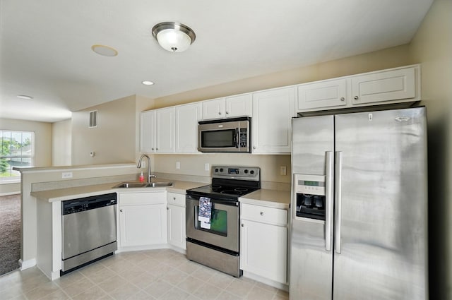 5629 Middle Falls St, Dublin, OH 43016 - kitchen with stainless steel appliances, white cabinets, a peninsula, light countertops, and recessed lighting