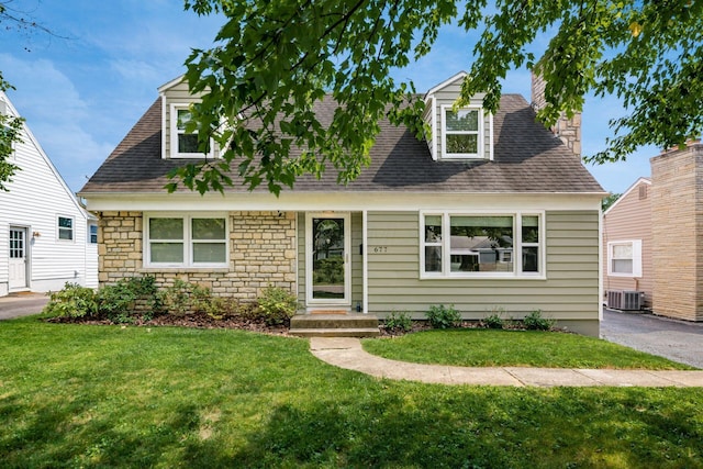 677 E Weisheimer Rd, Columbus, OH 43214 - cape cod home with central air condition unit, a front yard, stone siding, and roof with shingles
