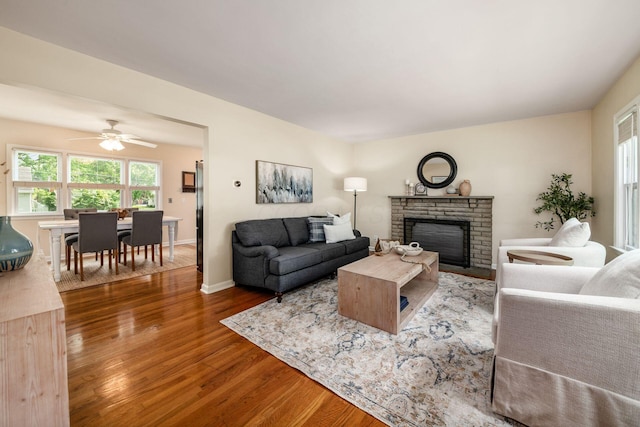 677 E Weisheimer Rd, Columbus, OH 43214 - living area featuring wood finished floors, a fireplace, healthy amount of natural light, and ceiling fan