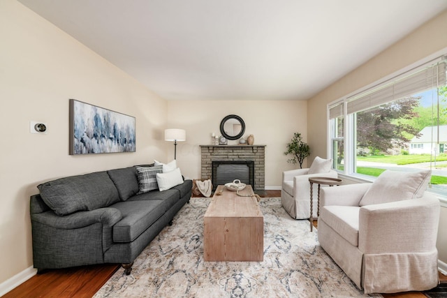 677 E Weisheimer Rd, Columbus, OH 43214 - living area with wood finished floors, baseboards, and a fireplace