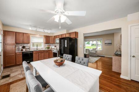 677 E Weisheimer Rd, Columbus, OH 43214 - dining space featuring ceiling fan, wood finished floors, baseboards, and rail lighting