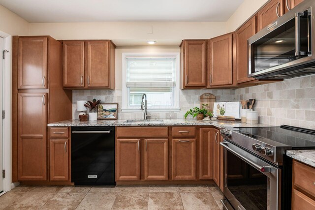 677 E Weisheimer Rd, Columbus, OH 43214 - kitchen featuring appliances with stainless steel finishes, a sink, and brown cabinets