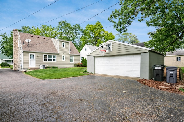 677 E Weisheimer Rd, Columbus, OH 43214 - view of side of property with a detached garage, an outbuilding, a lawn, central AC unit, and a chimney