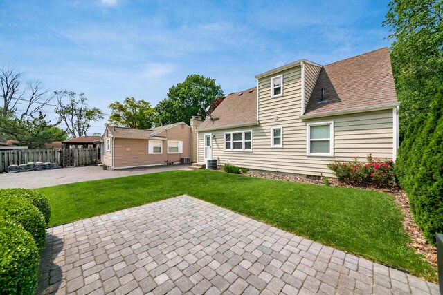 677 E Weisheimer Rd, Columbus, OH 43214 - rear view of property with a patio area, a shingled roof, entry steps, and central AC