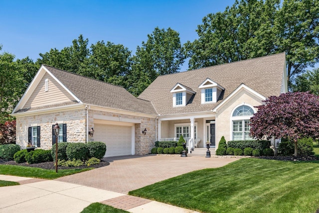 7908 Coldwater Dr, Powell, OH 43065 - view of front facade with a garage, a front lawn, decorative driveway, stone siding, and roof with shingles