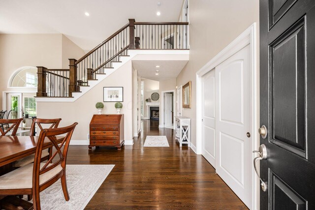 7908 Coldwater Dr, Powell, OH 43065 - foyer featuring a high ceiling, wood finished floors, stairway, a fireplace, and recessed lighting