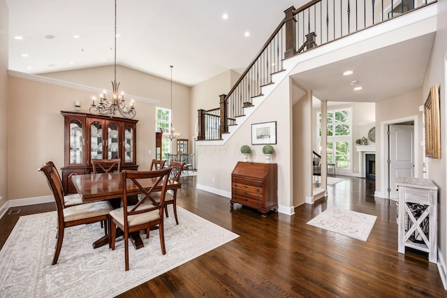 7908 Coldwater Dr, Powell, OH 43065 - dining room with a chandelier, healthy amount of natural light, high vaulted ceiling, dark wood-type flooring, and stairway