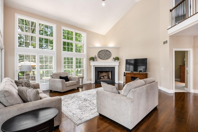 7908 Coldwater Dr, Powell, OH 43065 - living area featuring high vaulted ceiling, a fireplace with flush hearth, and dark wood-type flooring