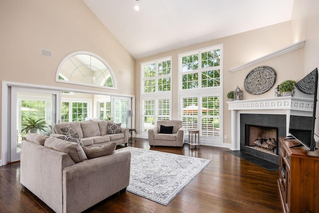 7908 Coldwater Dr, Powell, OH 43065 - living area featuring high vaulted ceiling, a fireplace with flush hearth, plenty of natural light, and dark wood-style floors